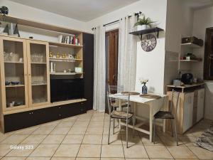 a kitchen with a table and chairs in a room at Mary House in Ladispoli +5 photos
