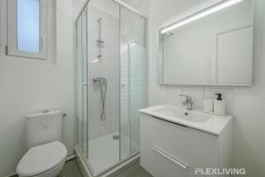 a white bathroom with a shower and a toilet and a sink at Flexliving - Chambre - Henri Sellier - Suresnes 92 in Suresnes