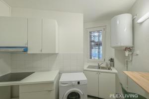 a white kitchen with a washing machine in it at Flexliving - Room - Henri Sellier - Suresnes 92 in Suresnes