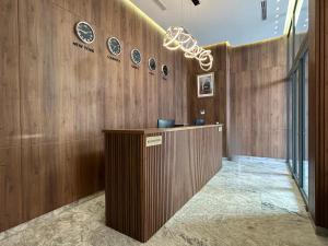 a lobby with a wooden wall with plates on it at Executive Boutique Hotel Rabat in Rabat