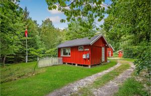 a red cabin in the middle of a yard at Skovlæ in Neksø +26 photos