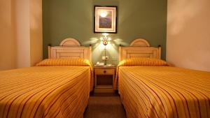 Postel nebo postele na pokoji v ubytování Hotel Los Bartolos