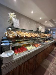 a buffet line with many different types of food at Real Palace Hotel in Rio de Janeiro
