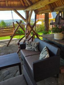 a couch sitting under a gazebo on a patio at Pokoje gościnne "U Prusa" in Murzasichle
