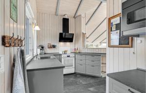 a kitchen with a sink and a stove at Klitbo in Rømø