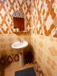 a bathroom with a sink and a mirror at Tukutane Kilimanjaro - Homestay in Uru +59 photos