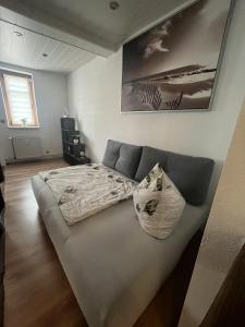 a large bed in a room with at Grünes Haus Dornburg in Dornburg