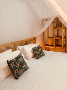 two twin beds in a room with a attic at Tukutane Kilimanjaro - Homestay in Uru