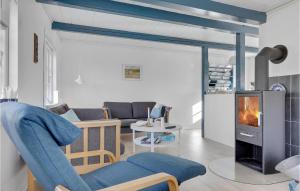 a living room with a fireplace and a couch at Fodermesterhuset in Gudhjem