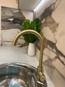 a sink with a faucet in a bathroom at Studio Peacock in Tympáki