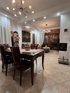a dining room with a table and chairs at Saguaro’s home Kavala in Kavála