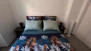 a bedroom with a bed with a colorful blanket and pillows at Appartement près de la gare St Charles in Marseille