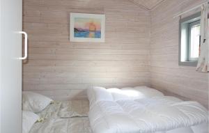 a room with a white wall with pillows in it at Stunning Home In Nexø With Wifi in Neksø +10 photos