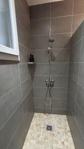 a shower with a hose in a tiled bathroom at Appartement près de la gare St Charles in Marseille +10 photos