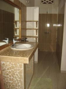 a bathroom with a sink and a shower at Babao in Mbour