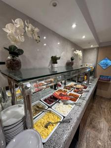 a buffet line with many different types of food at Real Palace Hotel in Rio de Janeiro +46 photos