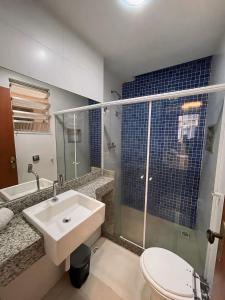 a bathroom with a sink and a toilet and a shower at Studio Living Flamengo in Rio de Janeiro