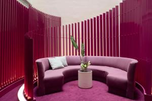 a room with a purple couch and a potted plant at Allegro Barcelona in Barcelona