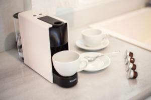 a coffee maker and two cups on a counter at Apanema Mindfulness Resort Lefkada - ultra fast Starlink WiFi in 2025 in Asprogerakata