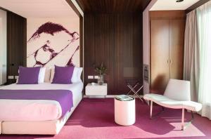 a bedroom with a large bed and a chair at Allegro Barcelona in Barcelona +51 photos