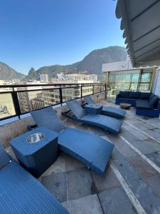 a patio with blue chairs and tables on a balcony at Real Palace Hotel in Rio de Janeiro