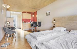 アリンエにあるStunning Apartment In Allinge With Wifiのベッドルーム1室(ベッド2台付)、キッチンが備わります。