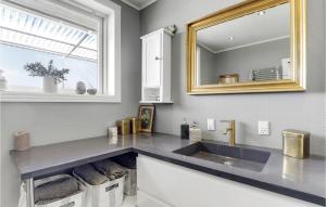 a bathroom with a sink and a mirror at Lovely Home In Gudhjem With Wifi in Gudhjem