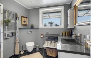 a bathroom with a sink and a toilet at Lovely Home In Gudhjem With Wifi in Gudhjem +1 photo