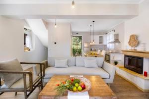 a living room with a couch and a table at Apanema Mindfulness Resort Lefkada - ultra fast Starlink WiFi in 2025 in Asprogerakata