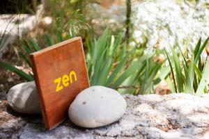 a zen sign sitting on top of some rocks at Apanema Mindfulness Resort Lefkada - ultra fast Starlink WiFi in 2025 in Asprogerakata