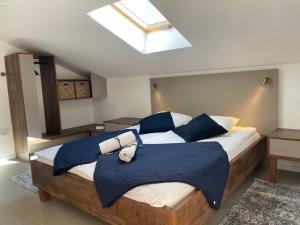 a bedroom with a large bed with blue pillows at Guest House Šulek in Punat