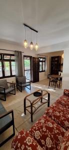 a room with two beds and tables and windows at Summer house in Urla "Apartment 1" in Urla
