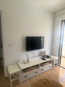 a living room with a flat screen tv on a wall at San Miguel Apartment Amadores Beach in Puerto Rico de Gran Canaria