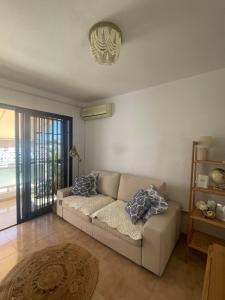 a living room with a couch and a window at San Miguel Apartment Amadores Beach in Puerto Rico de Gran Canaria
