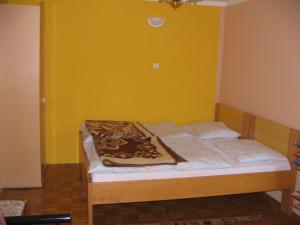 a bed in a room with a yellow wall at Apartment Milan in Zreče