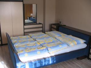 a bedroom with a bed with blue and yellow sheets at Apartment Milan in Zreče