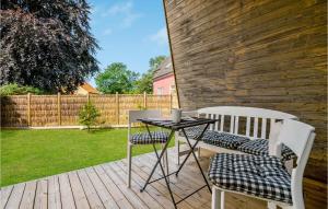 a patio with two chairs and a table at 1 Bedroom Cozy Home In Væggerløse in Marielyst