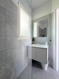 a white bathroom with a sink and a mirror at Dimora Dana in Pollutri +91 photos