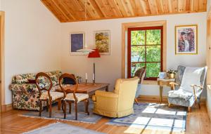 a living room with a couch and a table and chairs at Holiday Home Askholmen Kvicksund in Hållet
