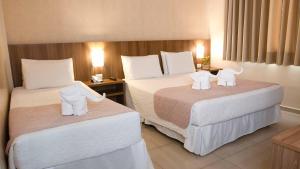 Postel nebo postele na pokoji v ubytování Pietro Angelo Hotel