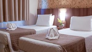 Postel nebo postele na pokoji v ubytování Pietro Angelo Hotel