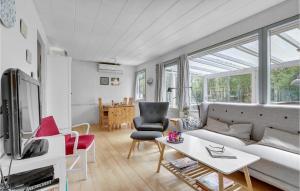 a living room with a couch and a table at Holiday Home Kabbelejevej Væggerløse Ix in Marielyst