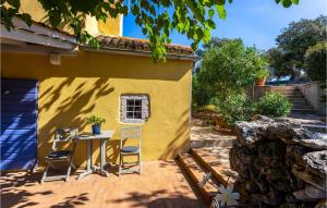 a patio with a table and chairs in front of a house at 2 Bedroom Lovely Home In Punta Kriza in Nerezine +34 photos