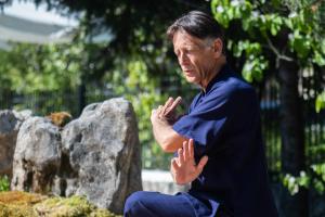a man sitting on a rock with his hands claspedly at Apanema Mindfulness Resort Lefkada - ultra fast Starlink WiFi in 2025 in Asprogerakata