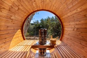 an inside view of a round window in a wooden sauna at Apanema Mindfulness Resort Lefkada - ultra fast Starlink WiFi in 2025 in Asprogerakata
