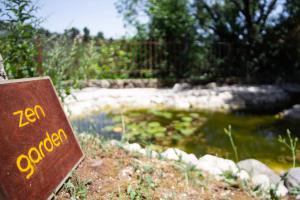 a sign that reads zen garden next to a pond at Apanema Mindfulness Resort Lefkada - ultra fast Starlink WiFi in 2025 in Asprogerakata
