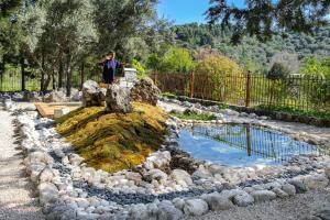 a person standing on top of a rock pool at Apanema Mindfulness Resort Lefkada - ultra fast Starlink WiFi in 2025 in Asprogerakata