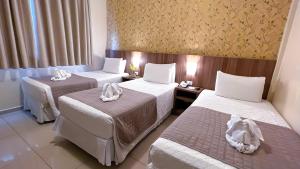Postel nebo postele na pokoji v ubytování Pietro Angelo Hotel