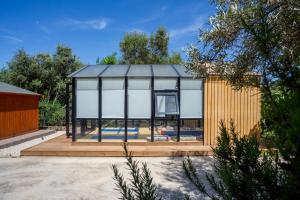 a glass house with a basketball hoop in it at Apanema Mindfulness Resort Lefkada - ultra fast Starlink WiFi in 2025 in Asprogerakata