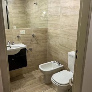 a bathroom with a toilet and a sink at Cielo Norteño in San Salvador de Jujuy +13 photos